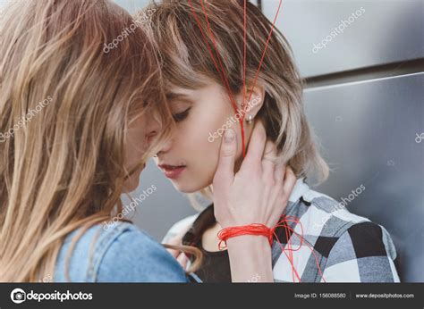 Young Lesbian Couple Kissing Stock Photo By ©dimabaranow 156088580