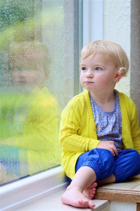 Little Girl Sitting Next Window On Rainy Day Stock Photo Image Of