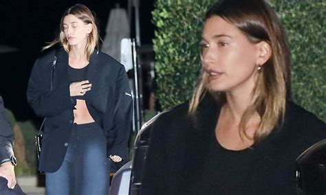 hailey bieber shows toned tum in black cropped top as she steps out for solo dinner at nobu