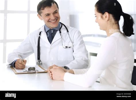 Doctor and patient discussing medical exam resoults at hospital office