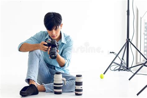 Young Photographer Is Taking Pictures In The Studio With A Digital