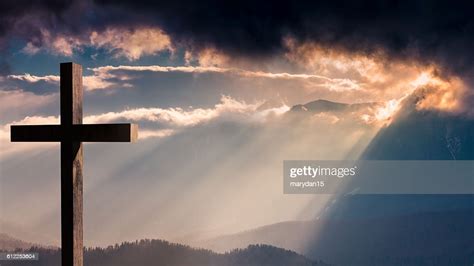 Jesus Christ Wooden Cross On A Dramatic Colorful Sunset High Res Stock