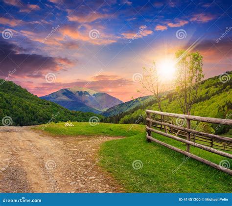 Fence On Hillside Meadow In Mountain At Sunset Stock Photo Image Of