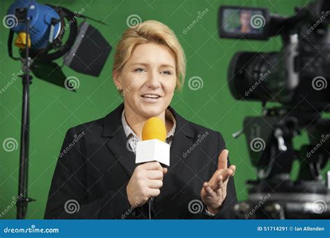 Female Journalist Presenting Report In Television Studio Stock Image