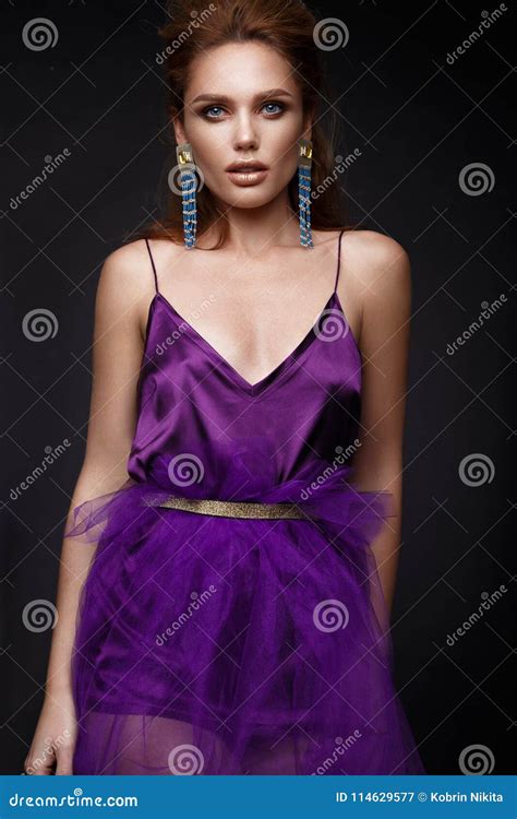 beautiful girl with sensual lips fashion hair purple dress and accessories beauty face stock