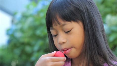 A Cute Little 6 Year Old Asian Girl Enjoys Licking Her Popsicle On A Hot Summers Day Stock