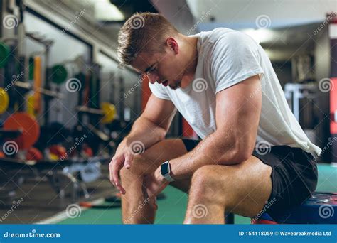 Tired Male Athlete Sitting In Fitness Center Stock Image Image Of