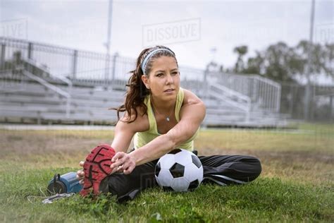 Soccer Player Stretching In Field Stock Photo Dissolve