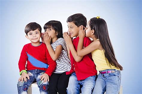 Four Kids Friends Whisper In Each Others Ear While Telling Secret