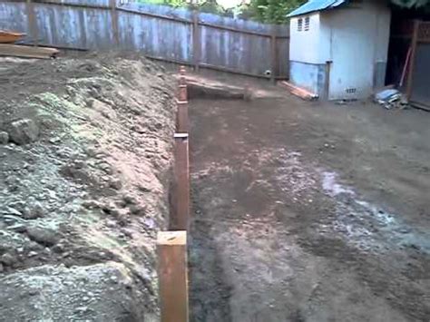 My wife saw a system for sale on the internet but i made my own for 1/4 of the price. Sloping yard we made to levels an put wood wall - YouTube