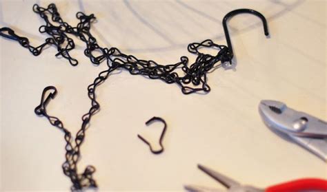 Scissors Chains And Pliers Are Laying On A White Surface With Black