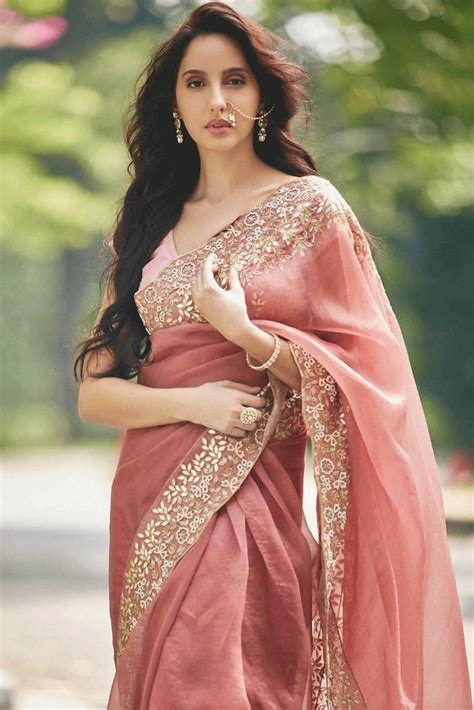 Nora fatehi shared a picture on her instagram page, where she was seen giving a side pose with a cute and classy white sling bag on her hand. Beautiful Nora Fatehi in Indian costume... | സാരിയില് ...