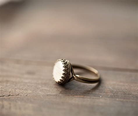 A Gold Ring Sitting On Top Of A Wooden Table