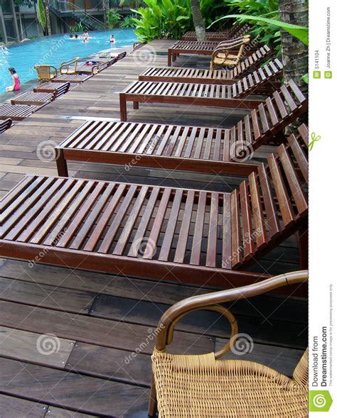 A decent deck chair can add a splash of vibrant colour to the patio, offer a serene relaxing spot and give you additional seating when you need it. Poolside Deck Chairs, Loungers Stock Photo - Image of blue ...