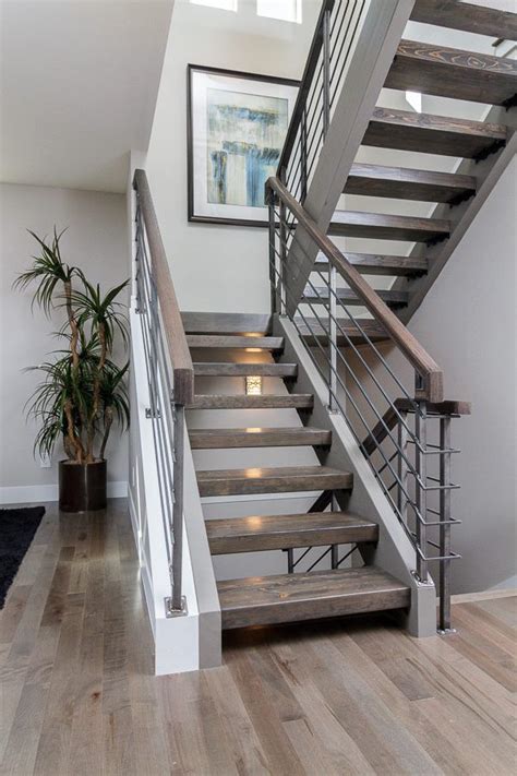 Custom Floating Stair Case With Hardwood Treads And A Metal Rail What
