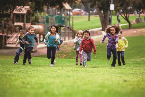 Group Of Young Children Running Towards Camera In Park Lphi