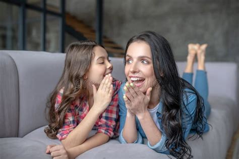 Dark Haired Girl Telling Something Interesting To Her Excited Mom In
