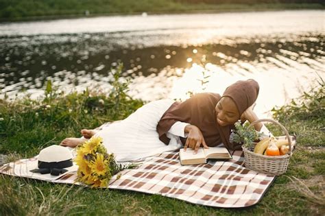 Free Photo A Muslim Woman Lay On The Plaid Picnic Blanket Near The