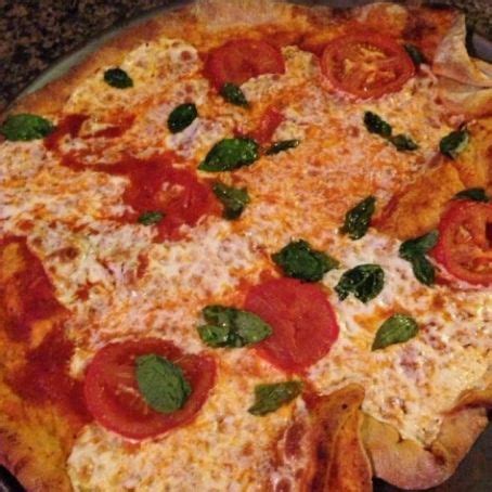 Brush pizza dough with 2 tablespoons olive oil. New York Style Thin Crust Pizza Recipe - (4.2/5)