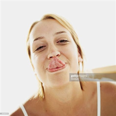 Portrait Of A Young Woman Sticking Her Tongue Out Photo Getty Images