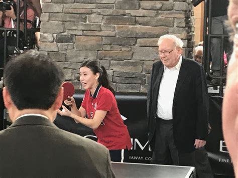 bill with u s olympic team member ariel hsing at ping pong match at berkshire hathaway event