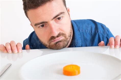 Sad And Frustrated Man On Diet Having Only Fruit For Meal Stock Photo