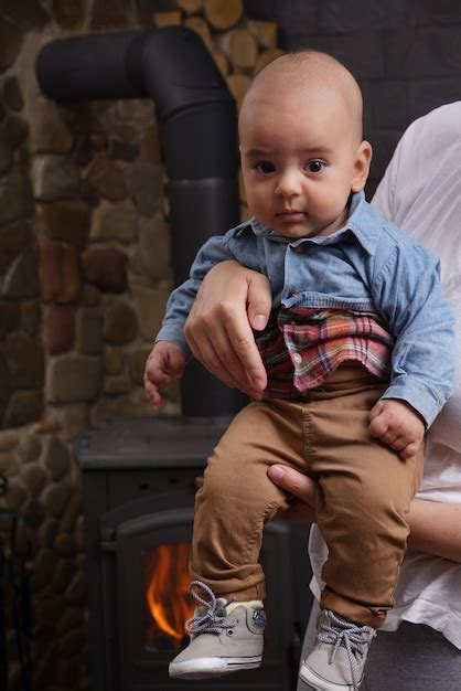 Premium Photo Adorable Baby Boy In Blue Denim Shirt And Brown Pants