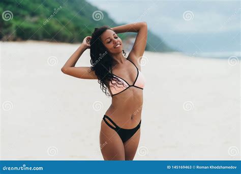 Slender Dark Skinned Girl In Swimwear Posing On Beach With Sand Afro