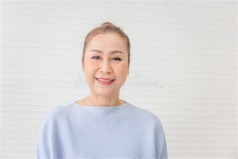 Portrait Of Happy Asian Woman In Living Room Relaxing Mature Middle Aged Woman Looking At
