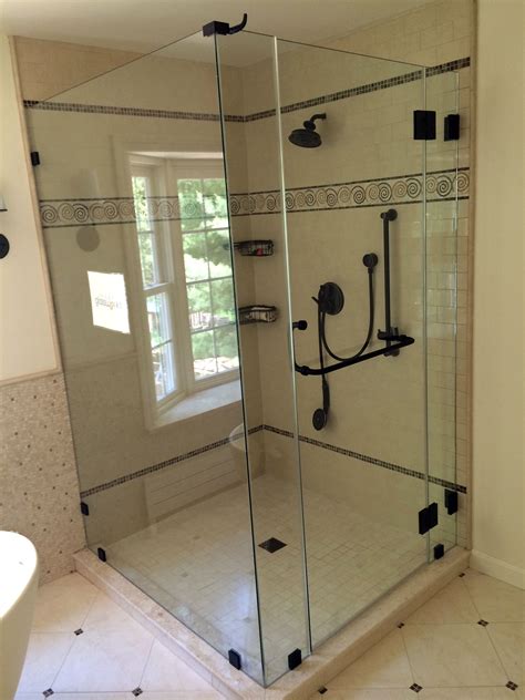 A Bathroom With A Walk In Shower Next To A Sink And Toilet On The Floor