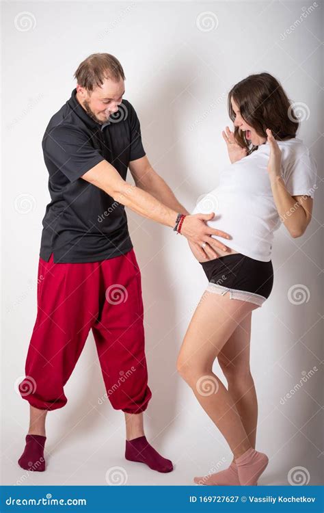 Handsome Man Is Listening To His Beautiful Pregnant Wife`s Tummy And Smiling Stock Image Image