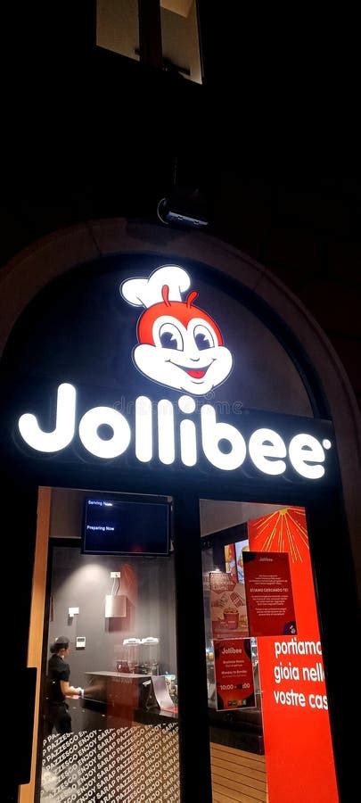 Illuminated Sign Of A Roman Branch Of The Filipino Fast Food Chain