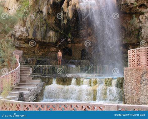A Tourist Enjoys The Hot Spring Waterfall And Natural Pool At Hammamat