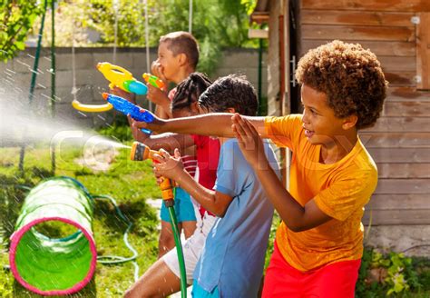 Water Gun Fight Game With Many Kids In Action Stock Image Colourbox