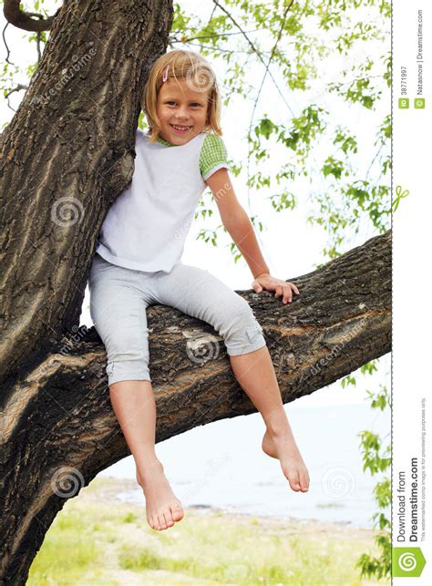 Cute Girl Sitting On A Tree In Summer Stock Image Image