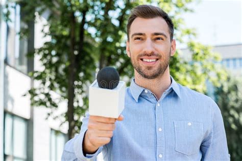 Smiling Male Journalist Taking Interview With Microphone Stock Image