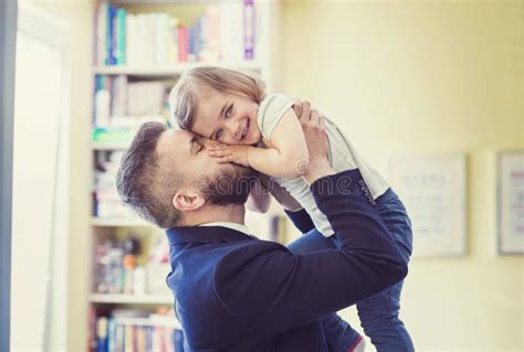 Padre Abrazando A Su Pequeña Hija Con Síndrome De Down En Casa Imagen
