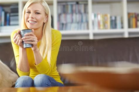Portrait One Beautiful Woman Sitting Alone On The Sofa In Her Living Room Smiling And Drinking