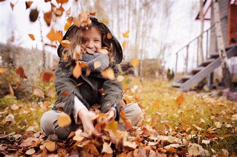 Happy Child Playing With Leaves In Autumn Seasonal Outdoor Activities