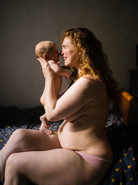 Naked Mom And Her Nude Newborn Son Sitting In Bed By Stocksy