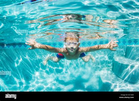 Underwater Young Boy Fun In The Swimming Pool With Goggles Summer