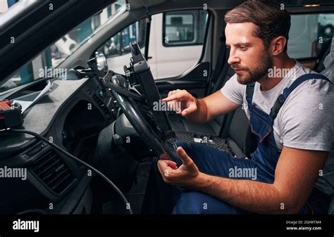 Young Automotive Repairman Is Scanning Car Settings Stock Photo Alamy