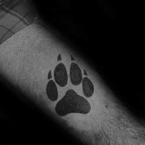 Small Simple Wolf Paw Forearm Solid Black Ink Tattoo On Guy Wolf Tattoos Feather Tattoos Star