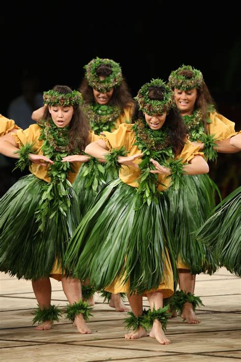 A Group Of Women Dressed In Grass Hula Skirts