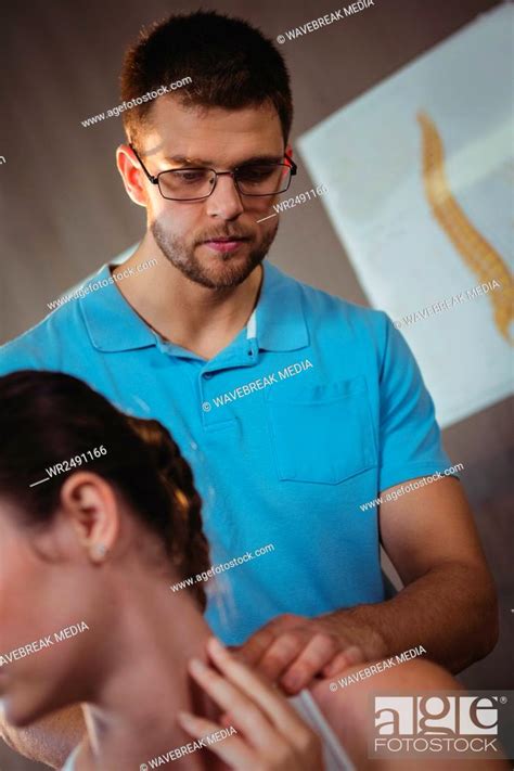Physiotherapist Stretching Neck Of A Female Patient Stock Photo