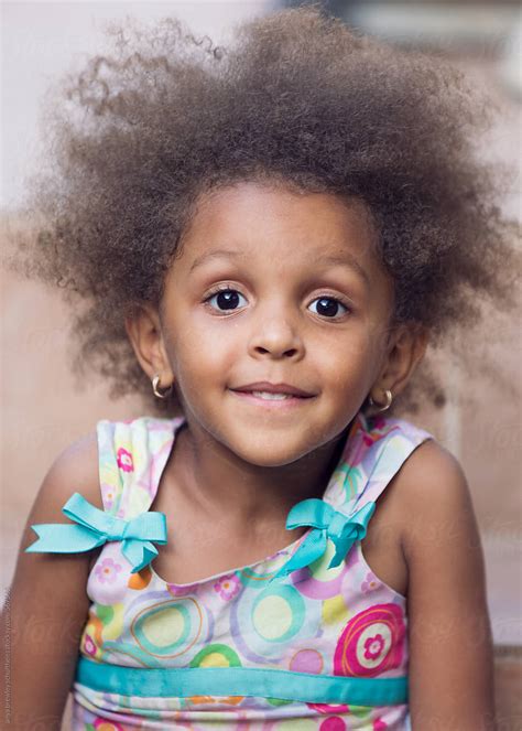 A Young Girl With Frizzy Brown Hair Smiling Sweetly By Stocksy Contributor Anya Brewley