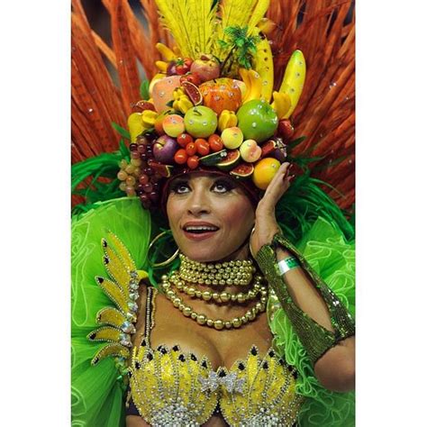 a member of academicos do salgueiro dances while wearing an elaborate headdress brazilian fruit