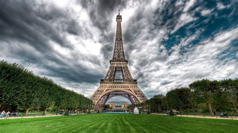 Eiffel Tower With Green Grass Field On Front With
