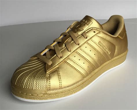 It was originally released in the early 1970s, but initially did not have a shell toe. this classic currently is available in canvas or. ADIDAS Women's Superstar Originals Shoes Sneakers Triple Gold Shell Toe BB8138 | eBay