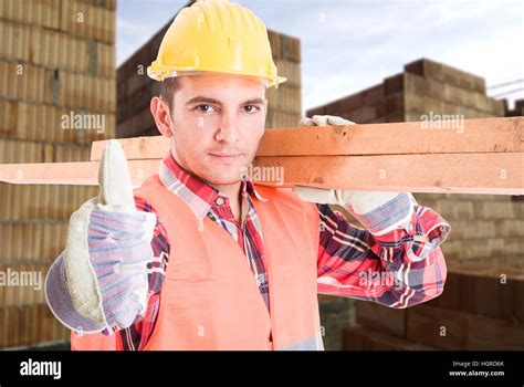 Portrait Of Young Builder Showing Thumb Up Sign Et La Tenue Des Pièces